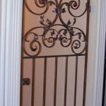 Wine Cellar Gate With Forged Scroll Arch Detail